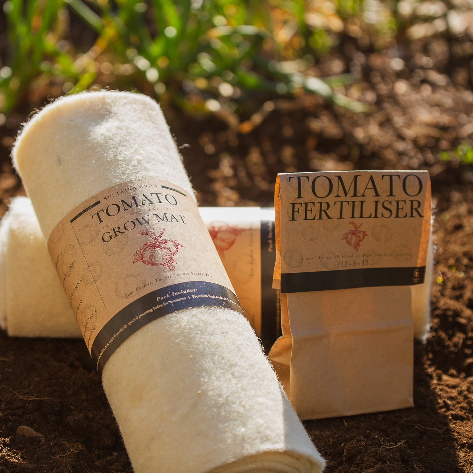 Roll of tomato grow mat and bag of tomato fertiliser on soil