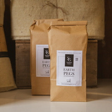 Bio degradable pegs for holding weed mat down 